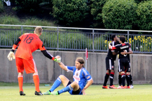 Zac MacMath helps up Jeff Parke after their giveaway led to Dwayne De Rosario's 40-yard goal to send the Union out of the 2013 U.S. Open Cup. (Photo: Paul Rudderow)