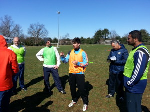 Rafael explains his "stage 3" exercise to the class, while Antonio takes notes