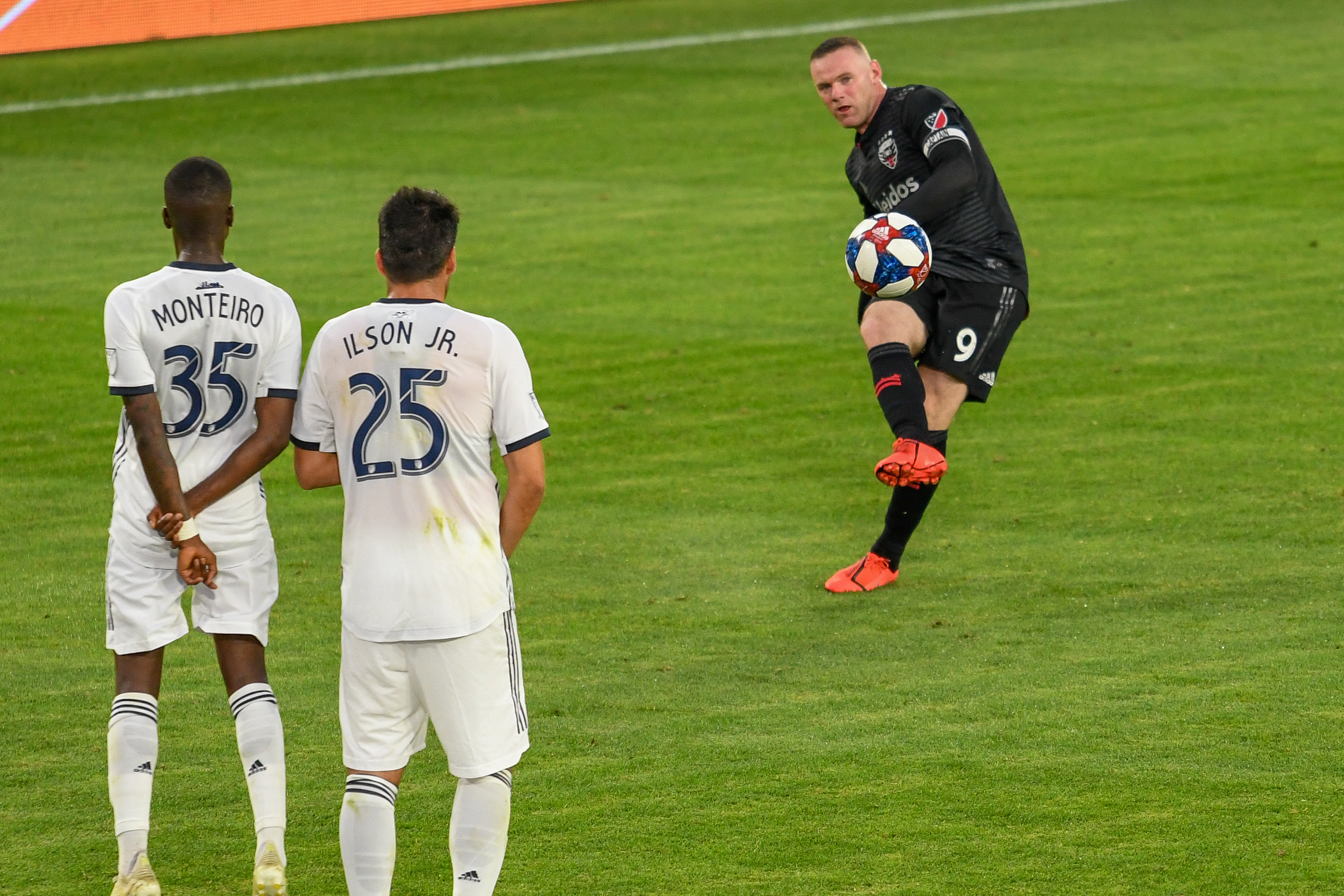 Wayne Rooney (9) takes a penalty kick with Monteiro (35) and Ilsinho(25) making the wall.